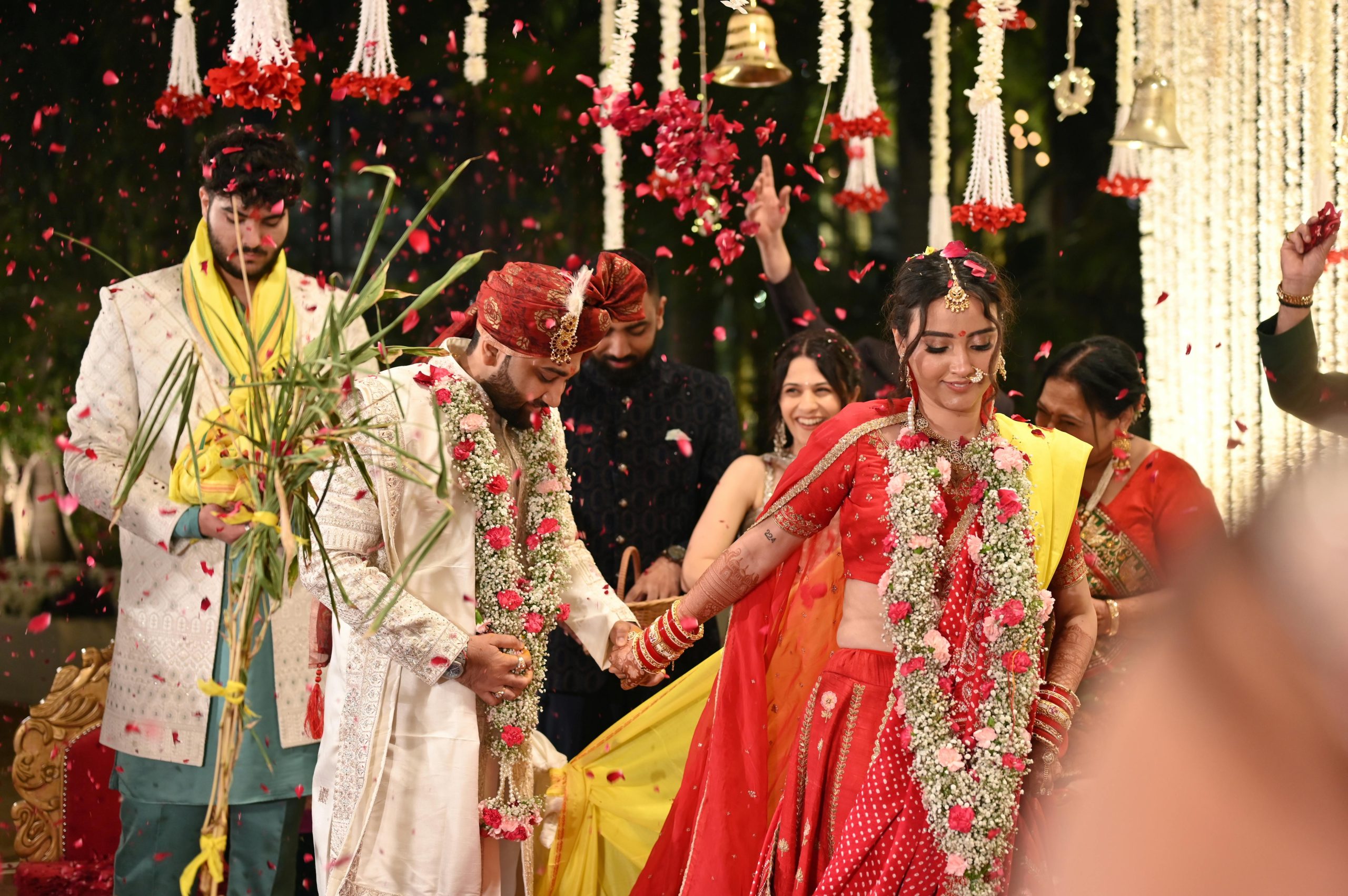 A vibrant, festive Indian wedding ceremony with flower petals and traditional attire, capturing joy and cultural heritage.